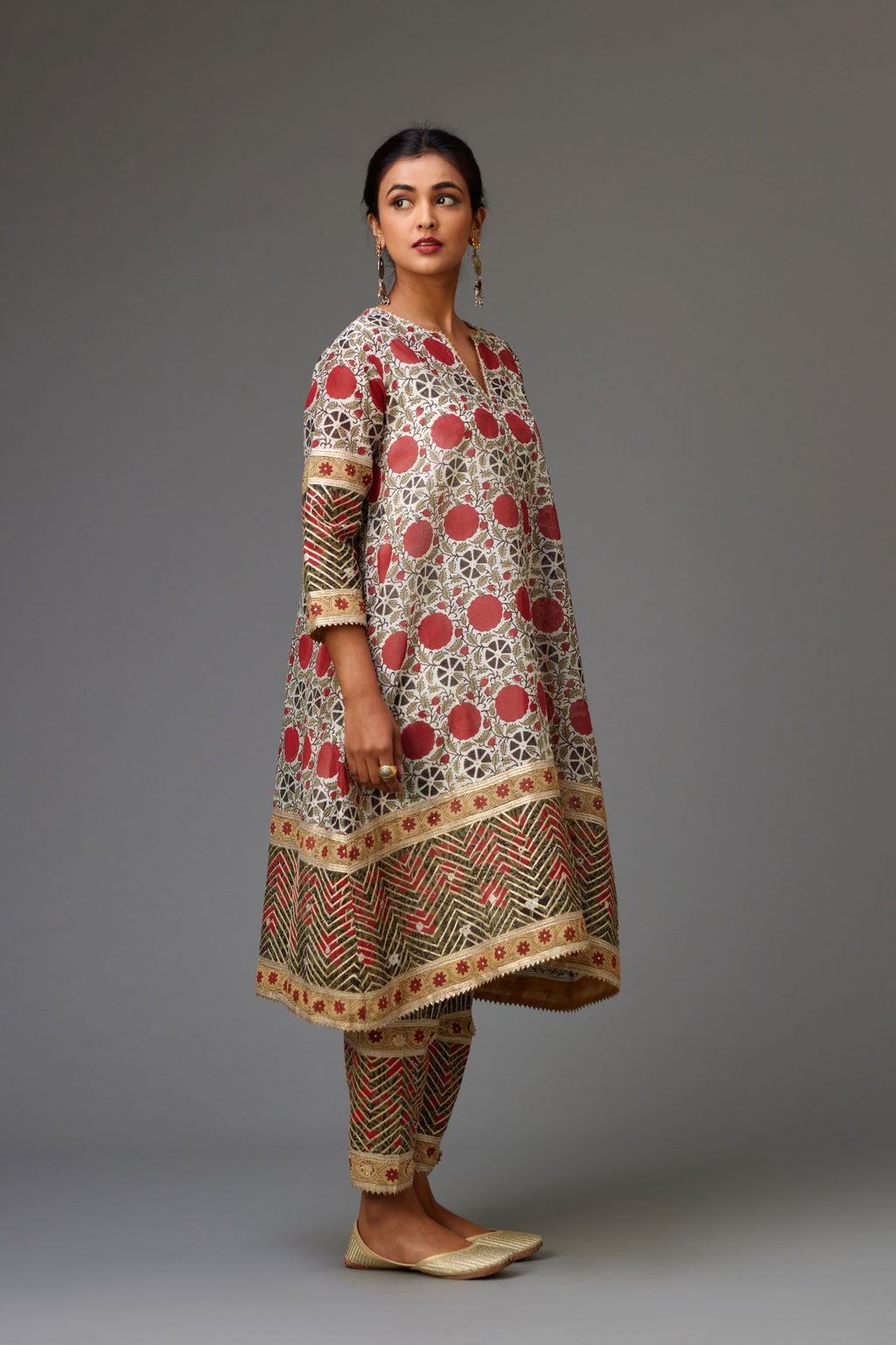Red and off white hand block printed short A-line kurta set, detailed with gold gota and flowers.