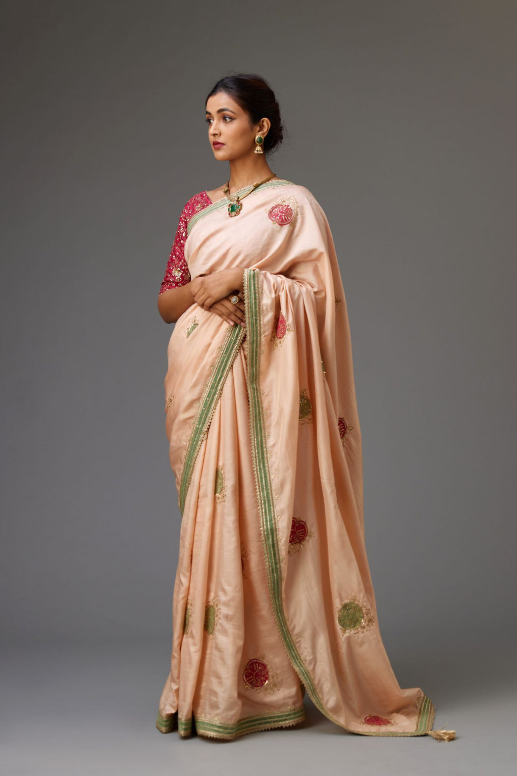 Pink silk saree set highlighted with all-over sequins embroidered boota and contrast colored border running along all edges.