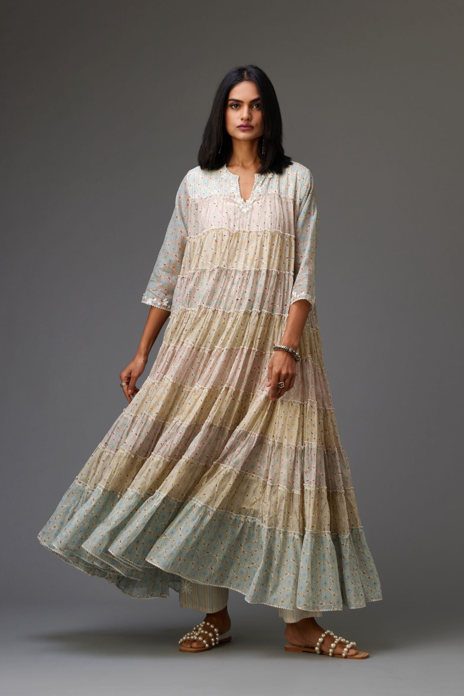 Mixed-print hand-block printed tiered kurta set with thread embroidery, highlighted with sequins.