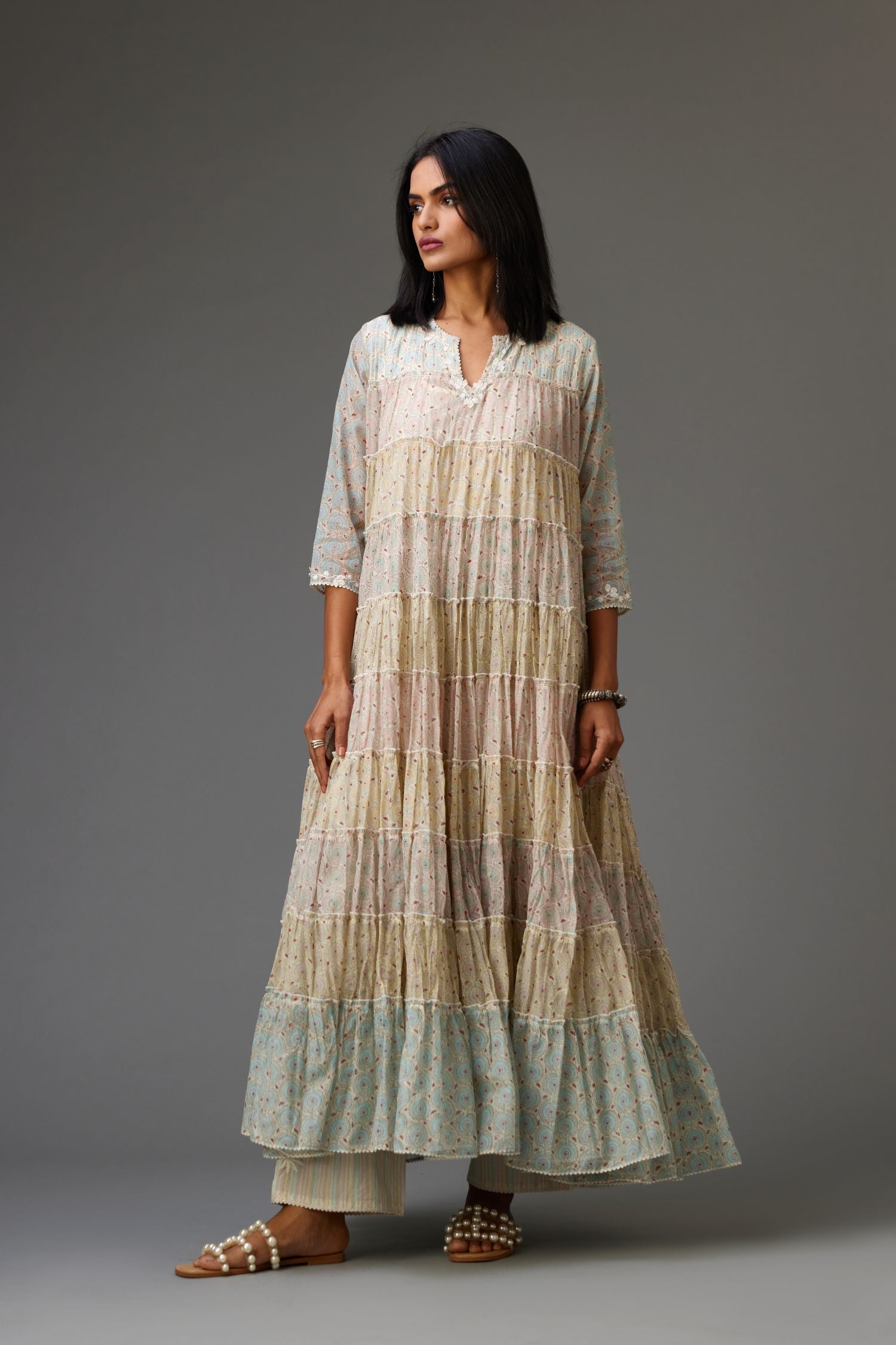 Mixed-print hand-block printed tiered kurta set with thread embroidery, highlighted with sequins.