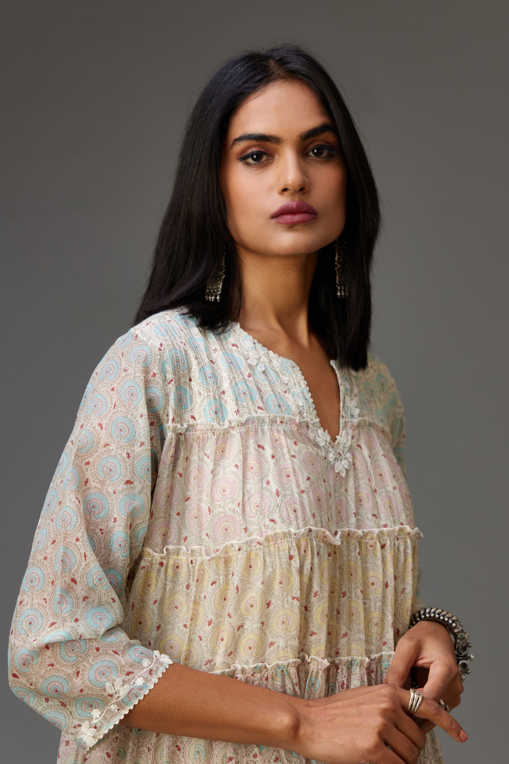 Mixed-print hand-block printed tiered kurta set with thread embroidery, highlighted with sequins.