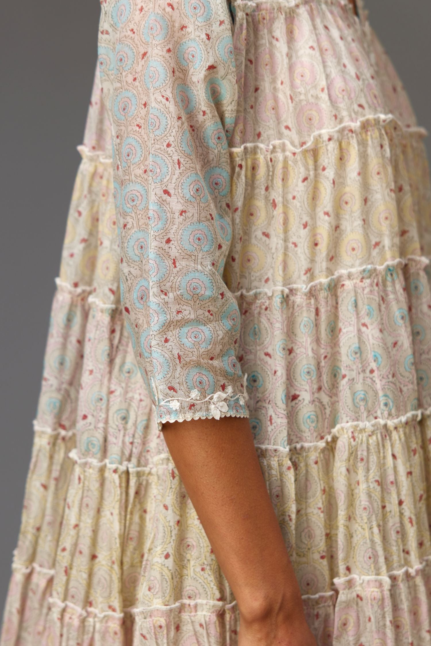 Mixed-print hand-block printed tiered kurta set with thread embroidery, highlighted with sequins.