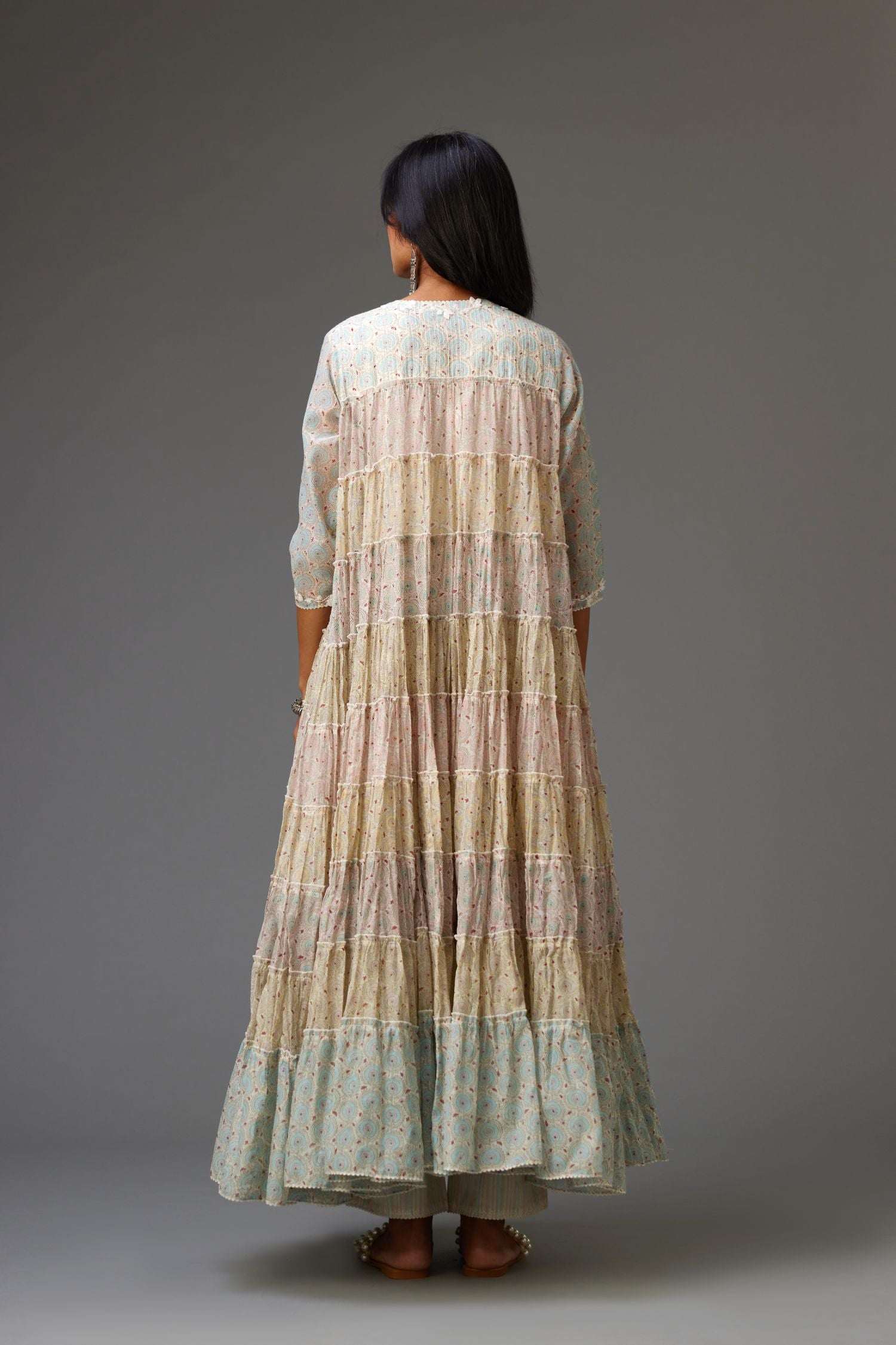 Mixed-print hand-block printed tiered kurta set with thread embroidery, highlighted with sequins.