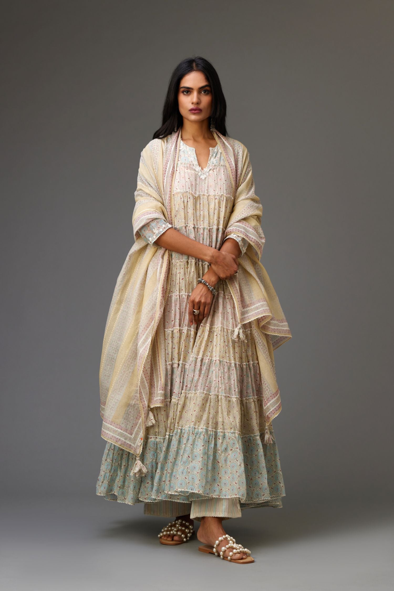 Mixed-print hand-block printed tiered kurta set with thread embroidery, highlighted with sequins.