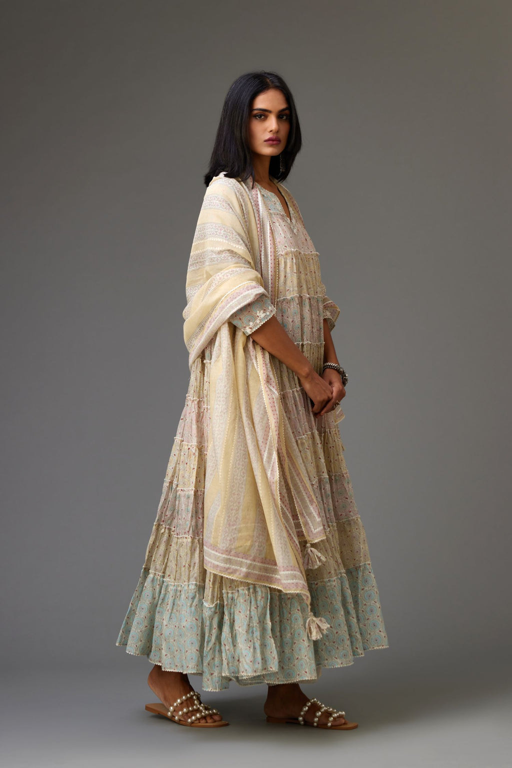 Mixed-print hand-block printed tiered kurta set with thread embroidery, highlighted with sequins.