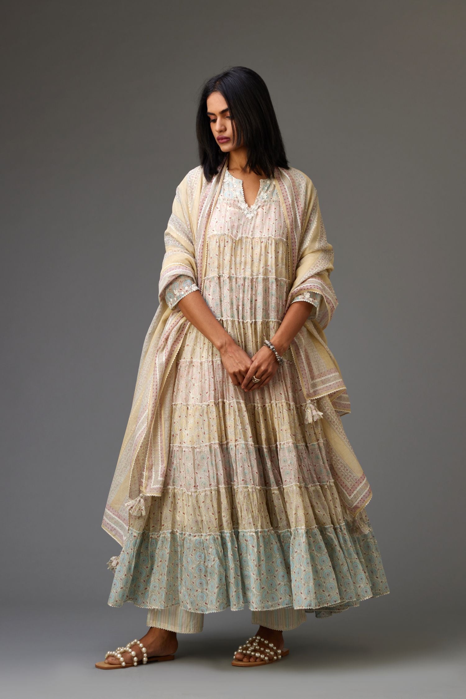 Mixed-print hand-block printed tiered kurta set with thread embroidery, highlighted with sequins.