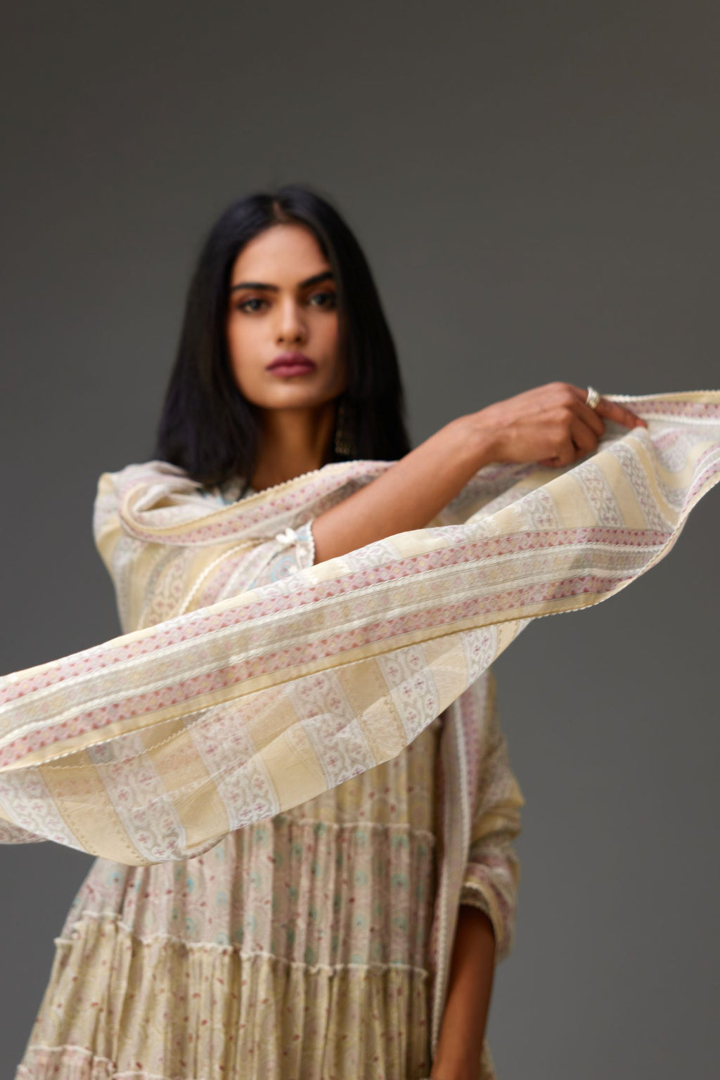Mixed-print hand-block printed tiered kurta set with thread embroidery, highlighted with sequins.