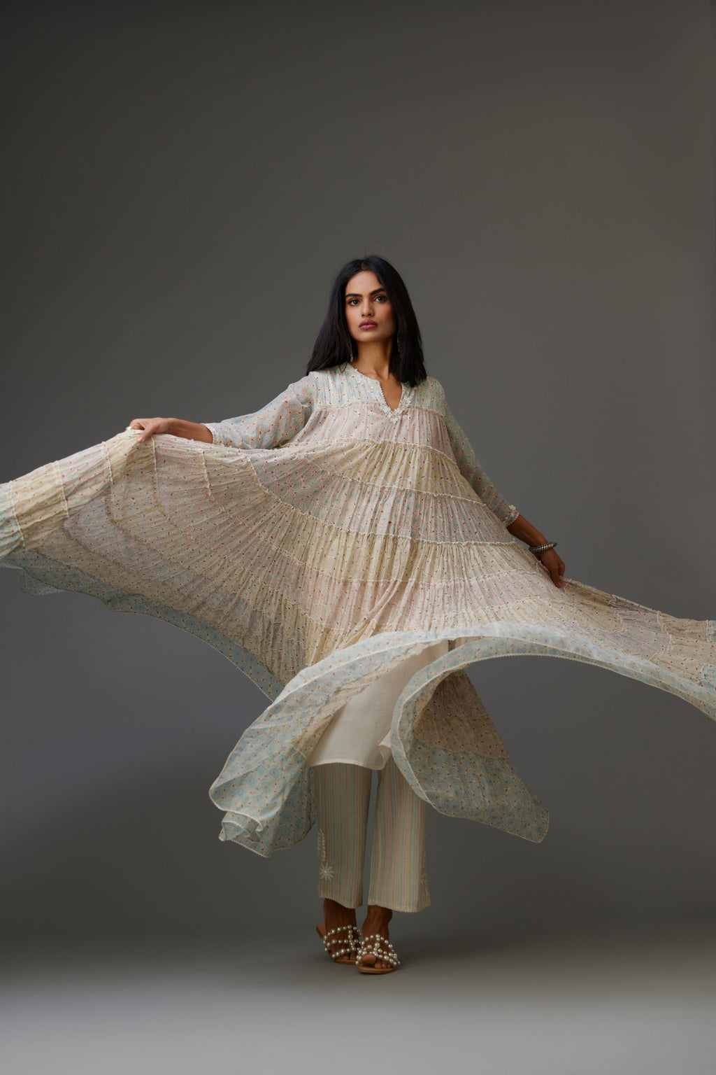 Mixed-print hand-block printed tiered kurta set with thread embroidery, highlighted with sequins.