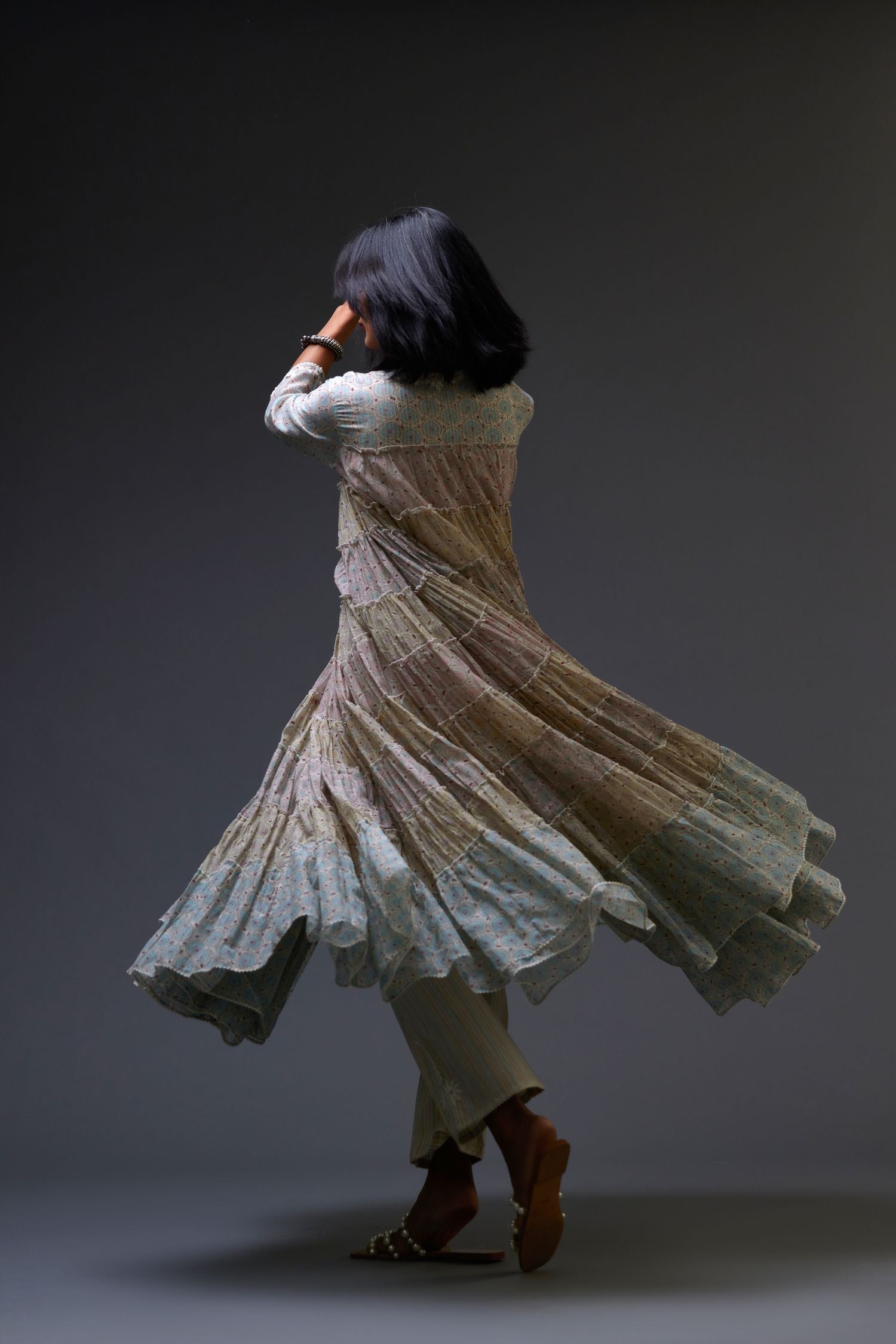 Mixed-print hand-block printed tiered kurta set with thread embroidery, highlighted with sequins.
