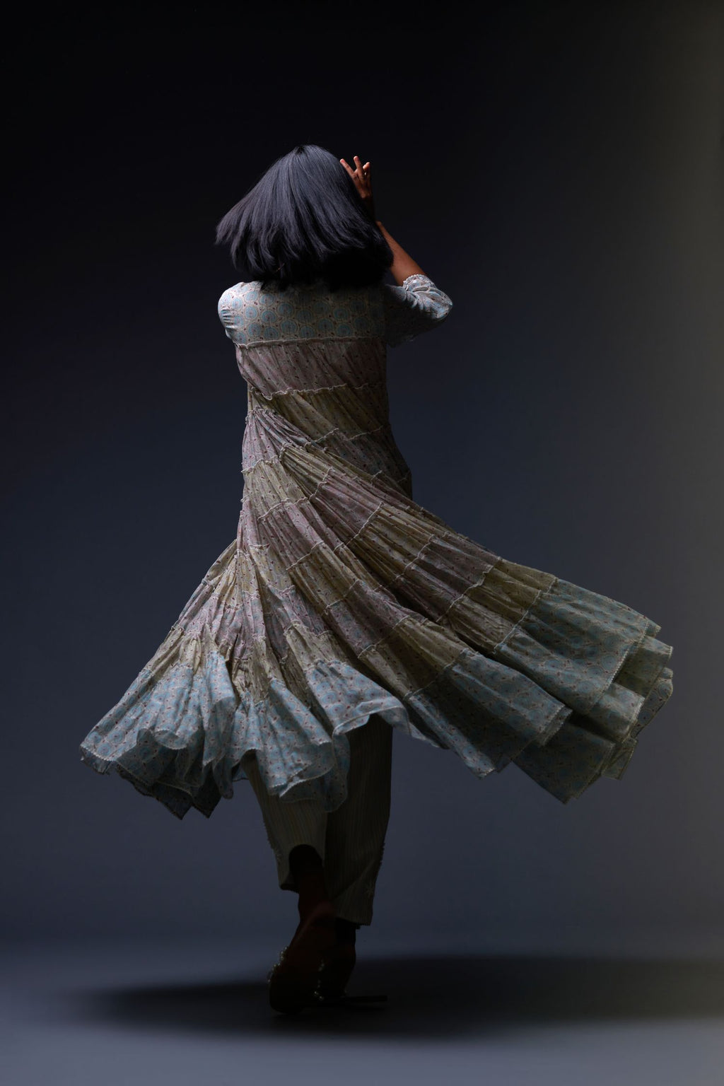 Mixed-print hand-block printed tiered kurta set with thread embroidery, highlighted with sequins.