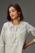 Silk chanderi hand-block printed straight kurta set with sequins work and chiffon flower embroidery.
