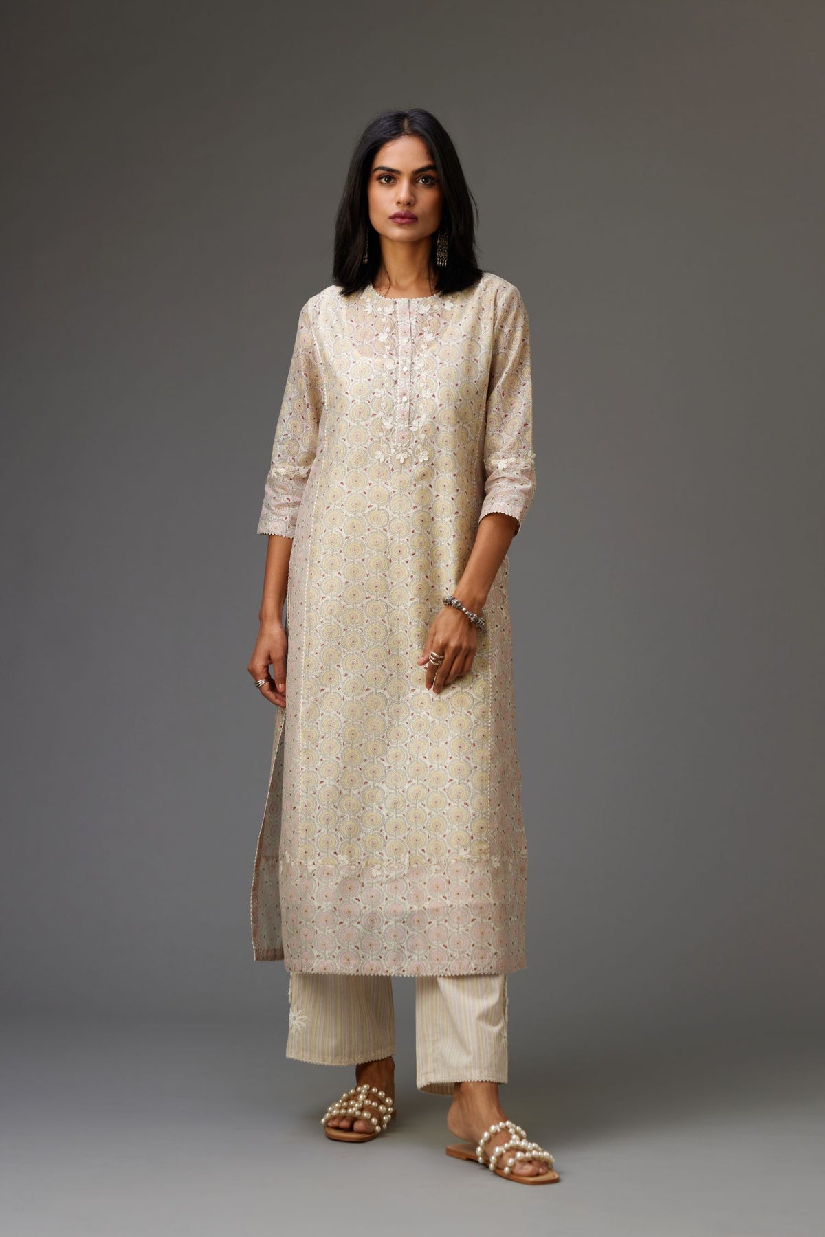 Multicolored mixed print hand-block printed straight kurta set with thread embroidery and chiffon flower buds at edges, highlighted with ric-rac lace.