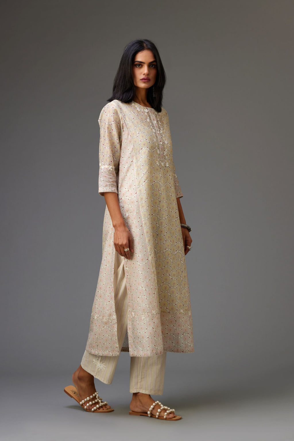 Multicolored mixed print hand-block printed straight kurta set with thread embroidery and chiffon flower buds at edges, highlighted with ric-rac lace.