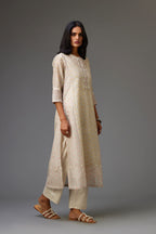 Multicolored mixed print hand-block printed straight kurta set with thread embroidery and chiffon flower buds at edges, highlighted with ric-rac lace.