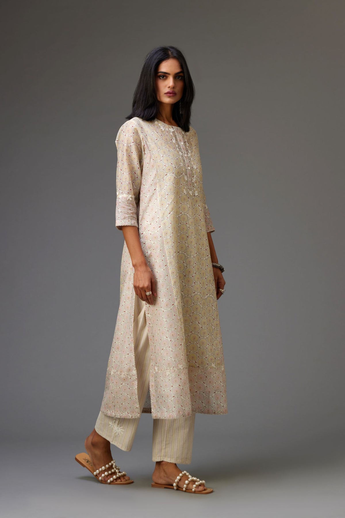 Multicolored mixed print hand-block printed straight kurta set with thread embroidery and chiffon flower buds at edges, highlighted with ric-rac lace.