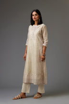 Multicolored mixed print hand-block printed straight kurta set with thread embroidery and chiffon flower buds at edges, highlighted with ric-rac lace.