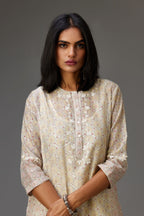 Multicolored mixed print hand-block printed straight kurta set with thread embroidery and chiffon flower buds at edges, highlighted with ric-rac lace.