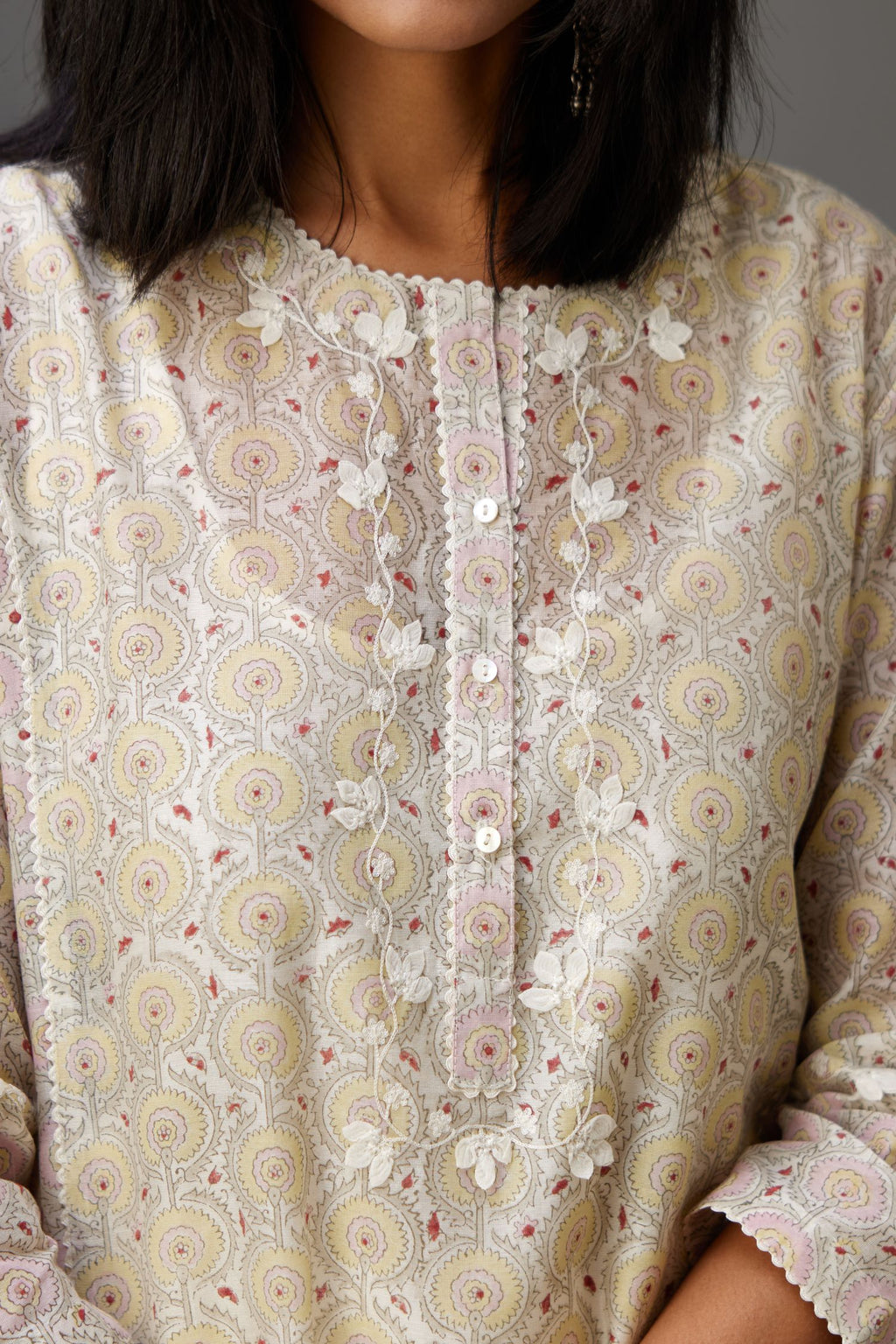 Multicolored mixed print hand-block printed straight kurta set with thread embroidery and chiffon flower buds at edges, highlighted with ric-rac lace.