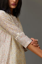 Multicolored mixed print hand-block printed straight kurta set with thread embroidery and chiffon flower buds at edges, highlighted with ric-rac lace.