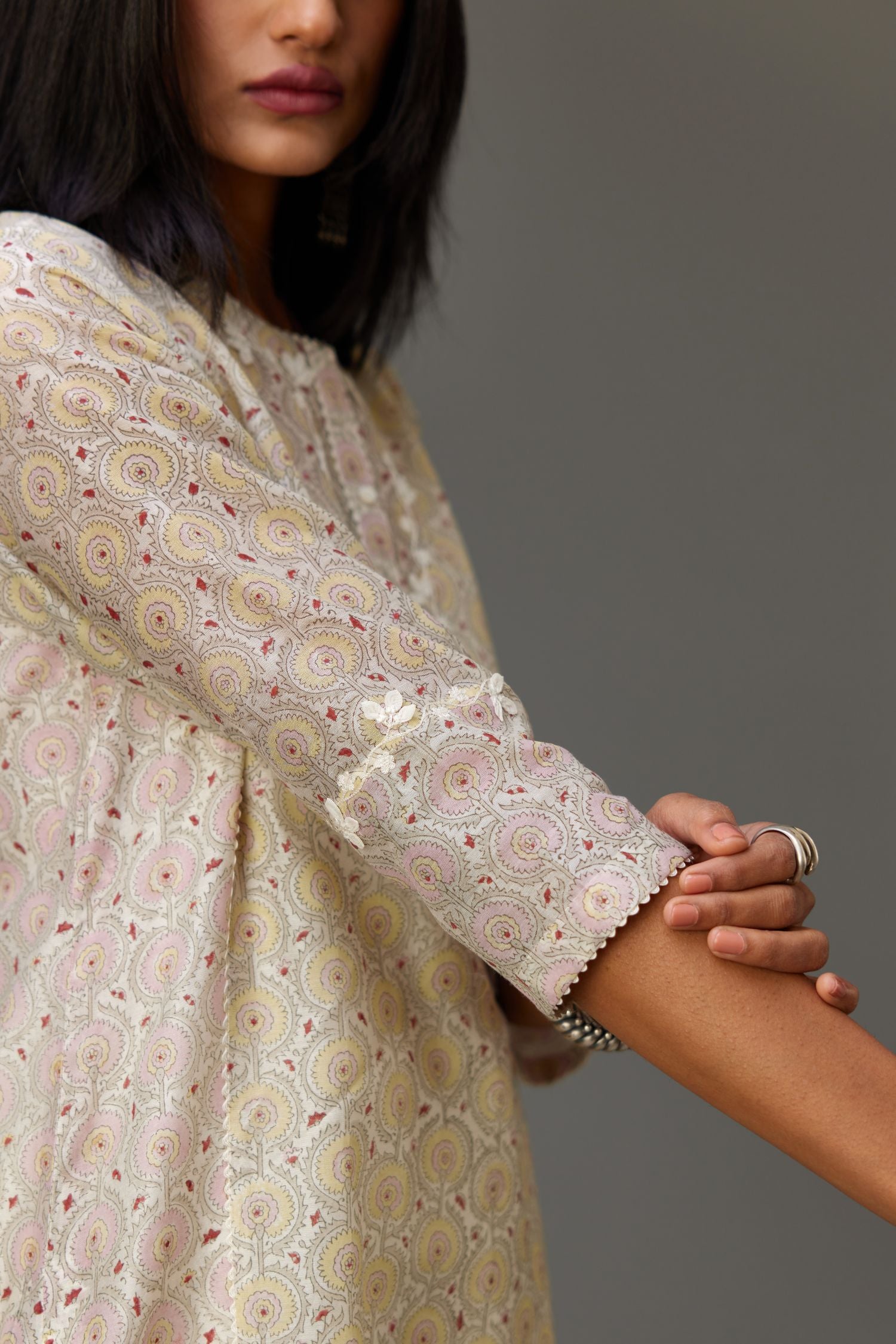 Multicolored mixed print hand-block printed straight kurta set with thread embroidery and chiffon flower buds at edges, highlighted with ric-rac lace.