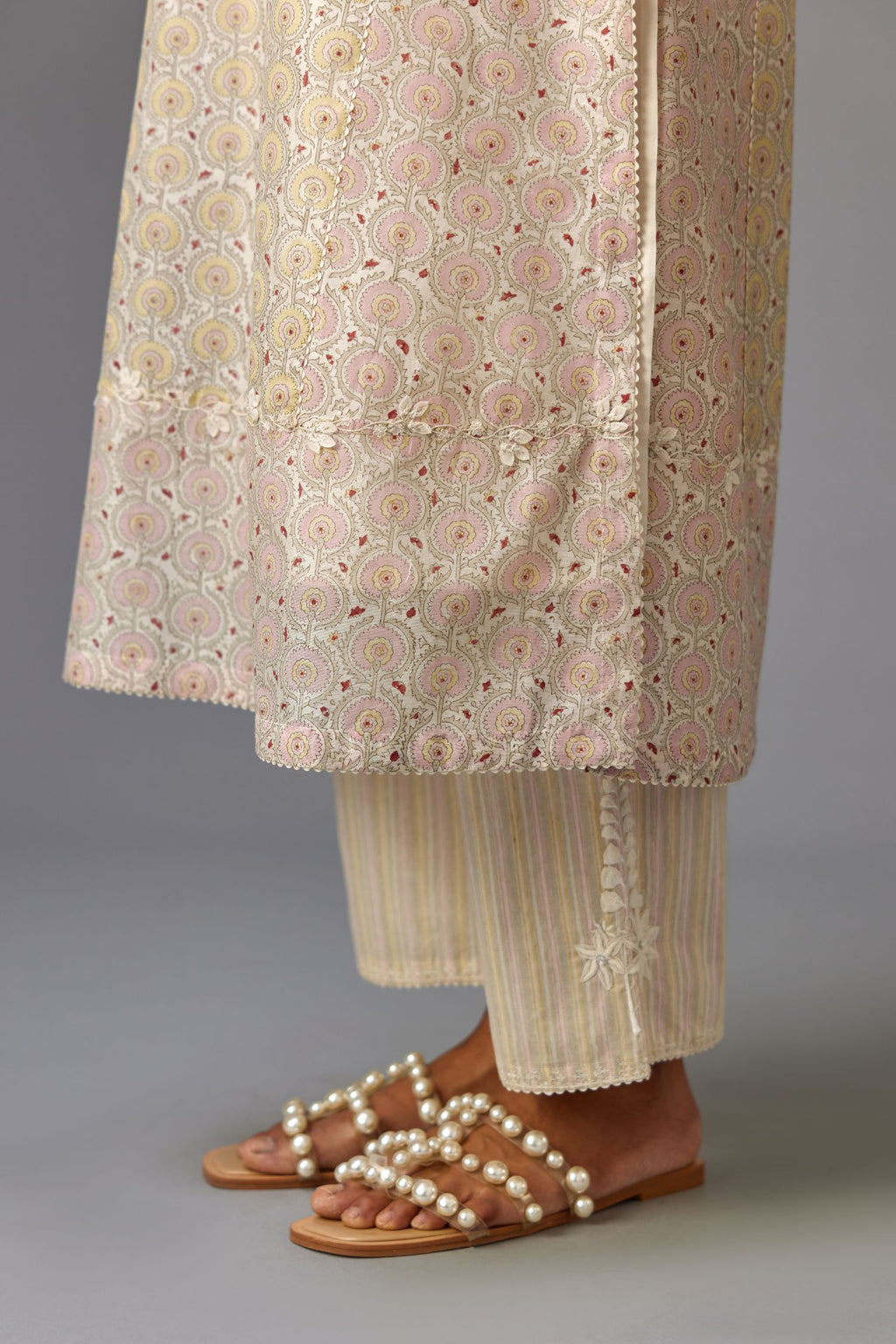 Multicolored mixed print hand-block printed straight kurta set with thread embroidery and chiffon flower buds at edges, highlighted with ric-rac lace.