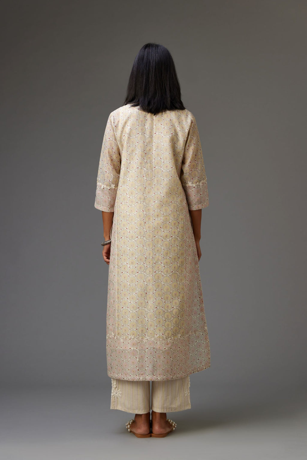 Multicolored mixed print hand-block printed straight kurta set with thread embroidery and chiffon flower buds at edges, highlighted with ric-rac lace.