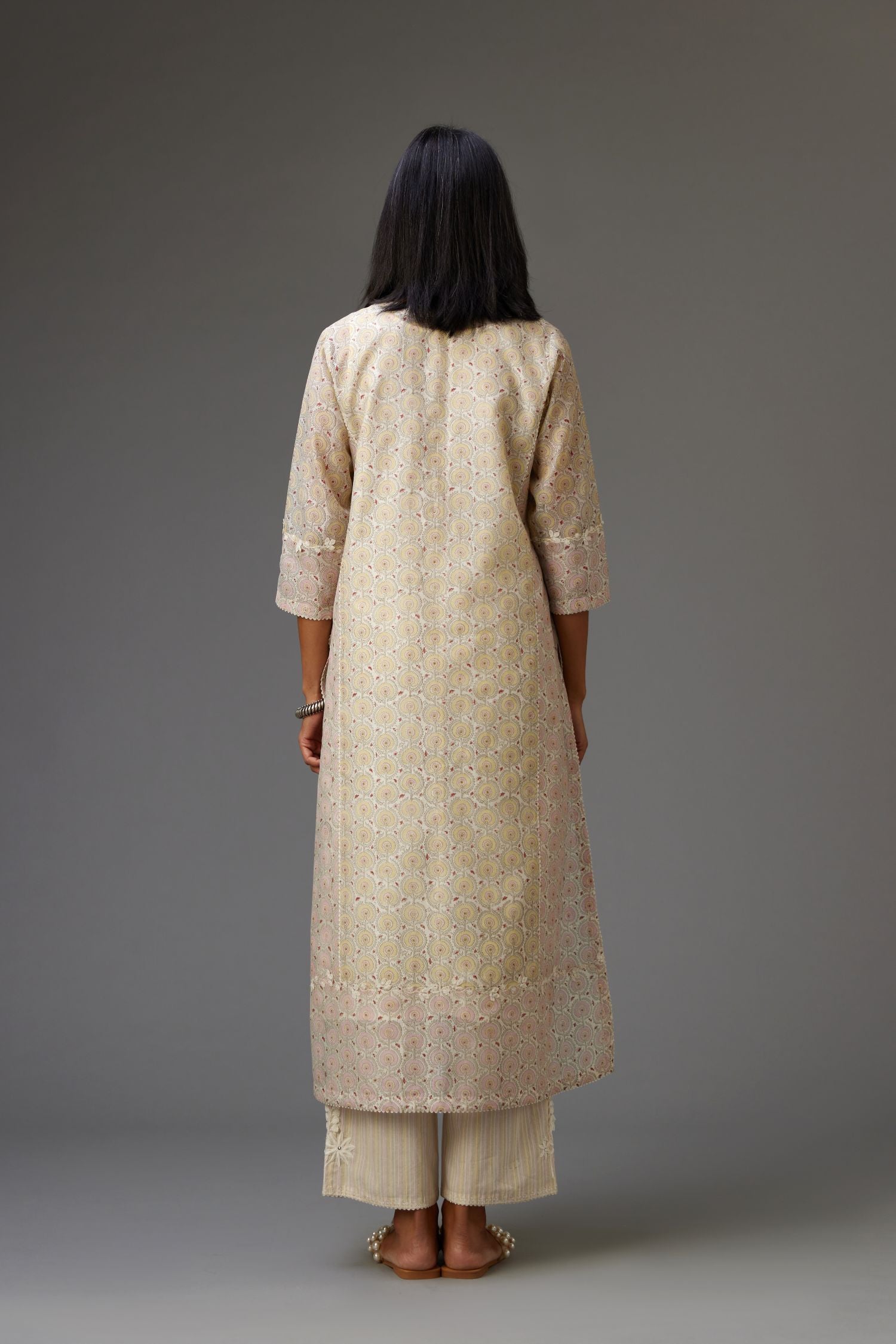 Multicolored mixed print hand-block printed straight kurta set with thread embroidery and chiffon flower buds at edges, highlighted with ric-rac lace.