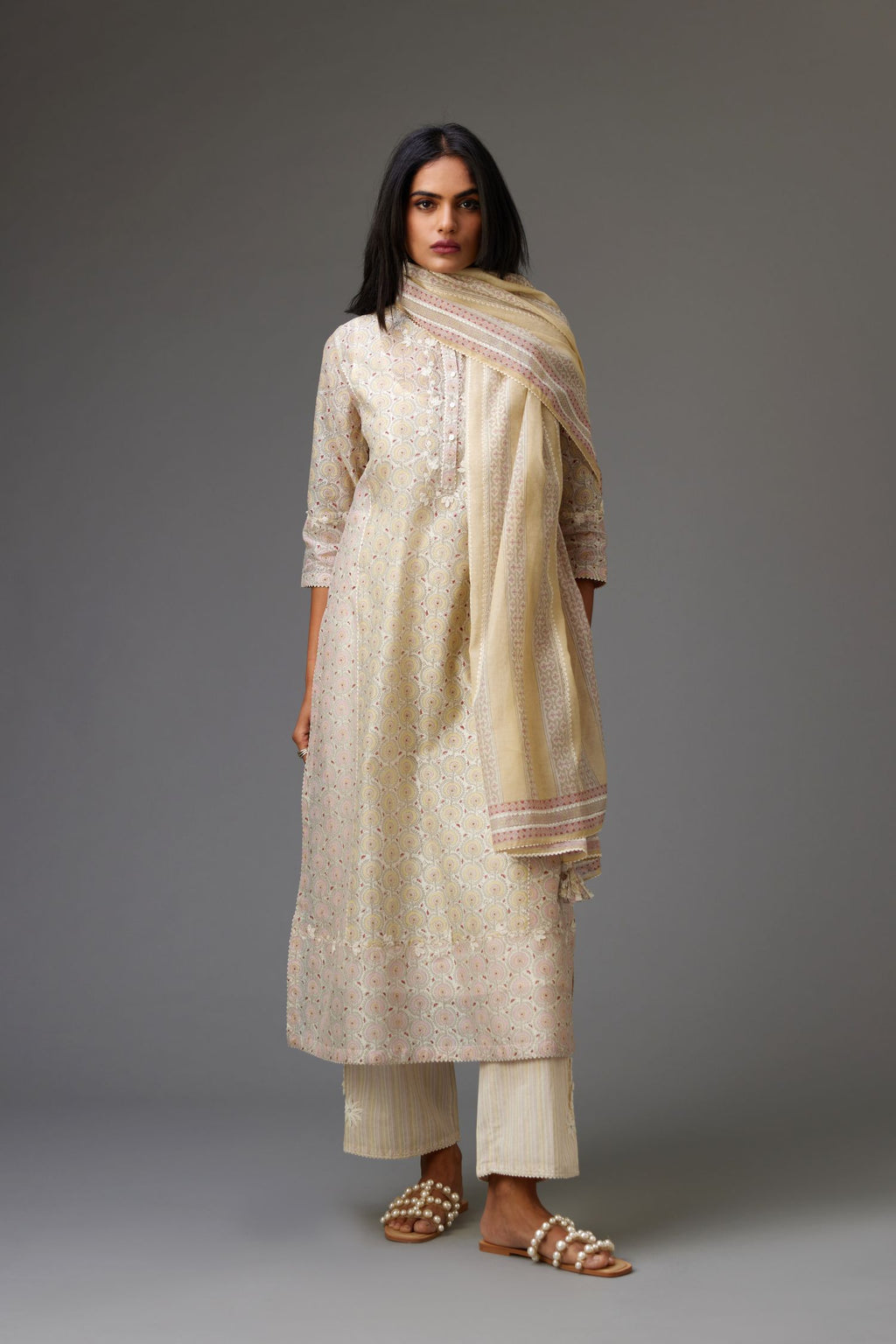 Multicolored mixed print hand-block printed straight kurta set with thread embroidery and chiffon flower buds at edges, highlighted with ric-rac lace.