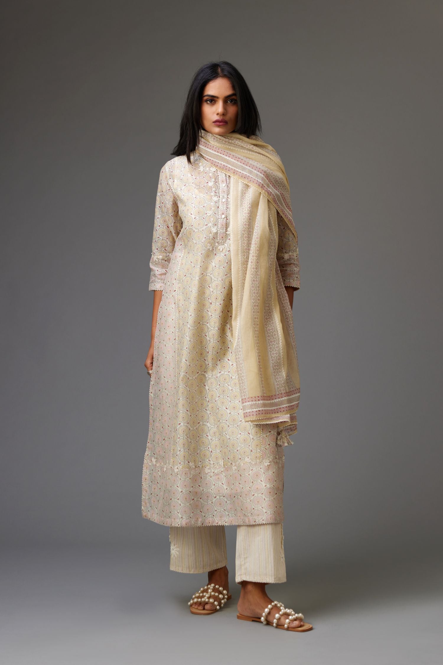 Multicolored mixed print hand-block printed straight kurta set with thread embroidery and chiffon flower buds at edges, highlighted with ric-rac lace.