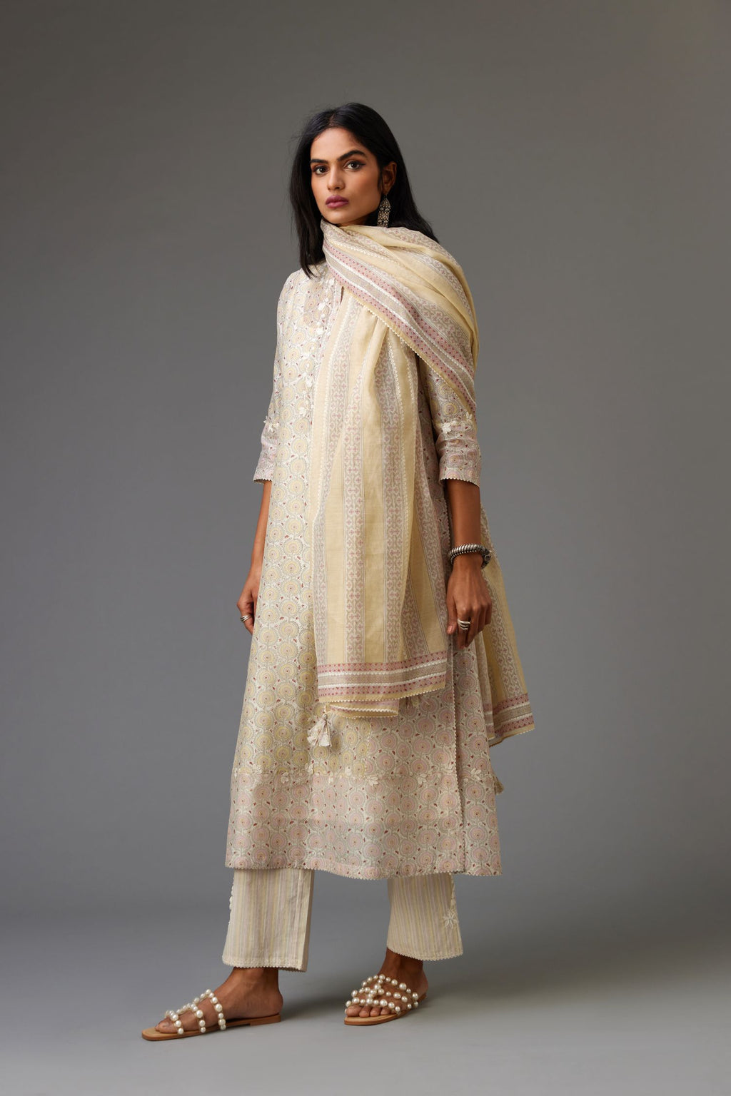 Multicolored mixed print hand-block printed straight kurta set with thread embroidery and chiffon flower buds at edges, highlighted with ric-rac lace.