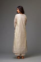 Silk Chanderi hand-block printed kurta set with multi-print panels, highlighted with white thread embroidery and chiffon flowers.