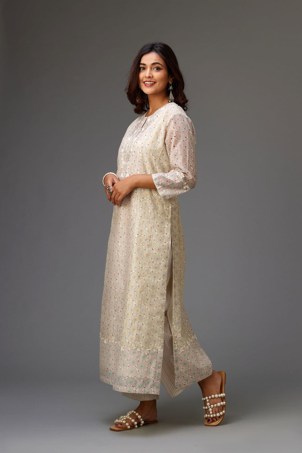 Silk Chanderi hand-block printed kurta set with multi-print panels, highlighted with white thread embroidery and chiffon flowers.