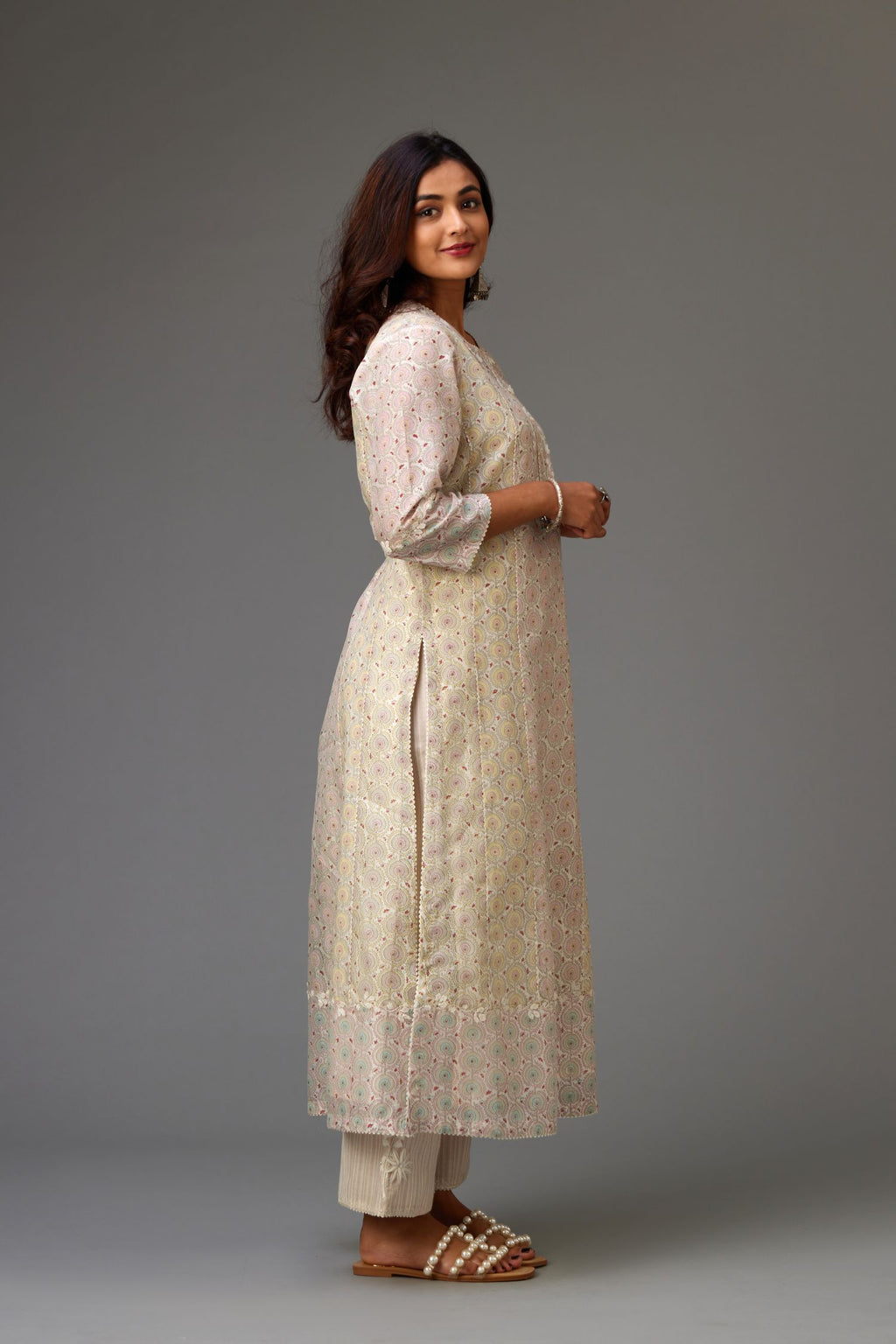 Silk Chanderi hand-block printed kurta set with multi-print panels, highlighted with white thread embroidery and chiffon flowers.