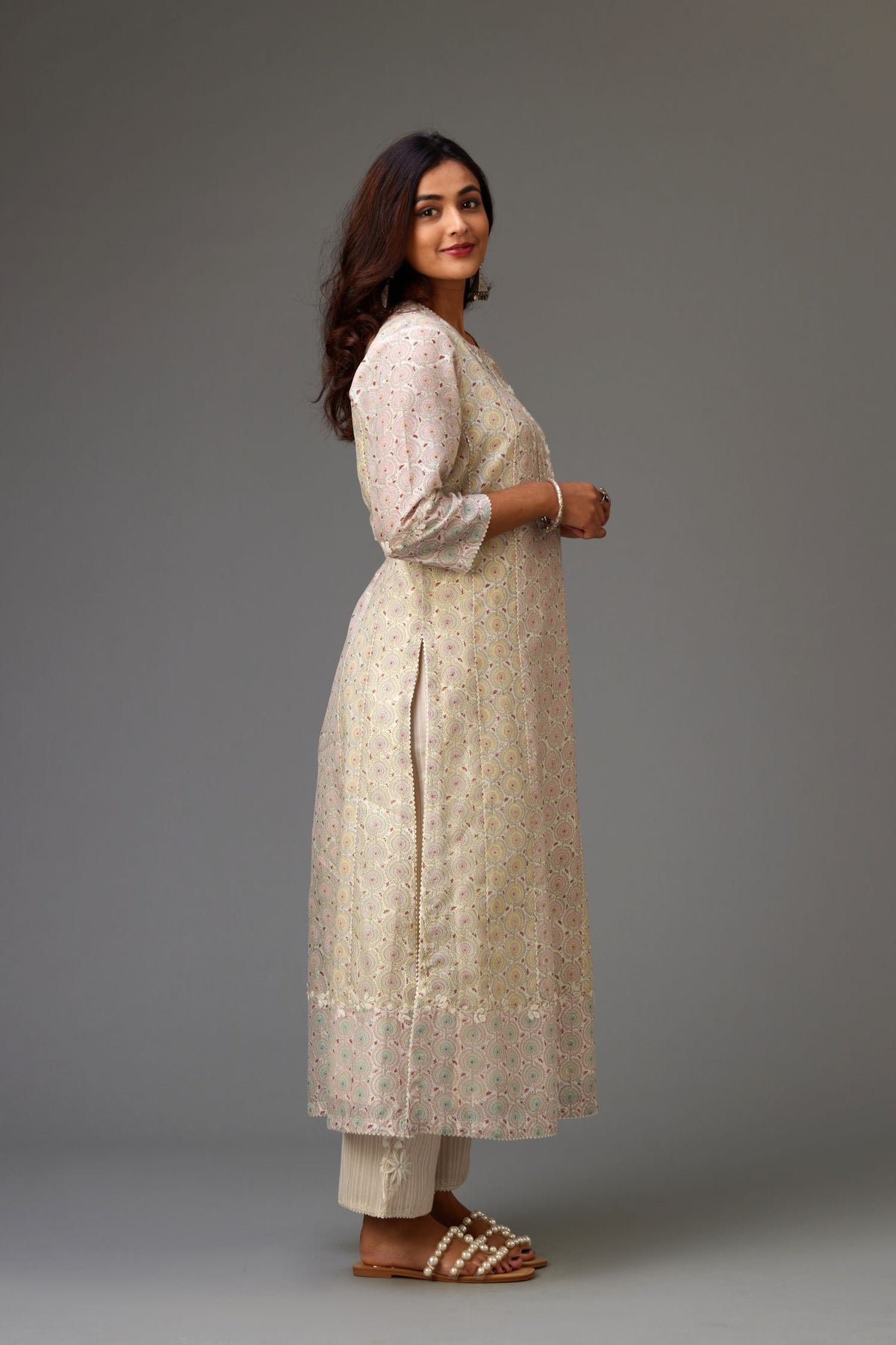 Silk Chanderi hand-block printed kurta set with multi-print panels, highlighted with white thread embroidery and chiffon flowers.