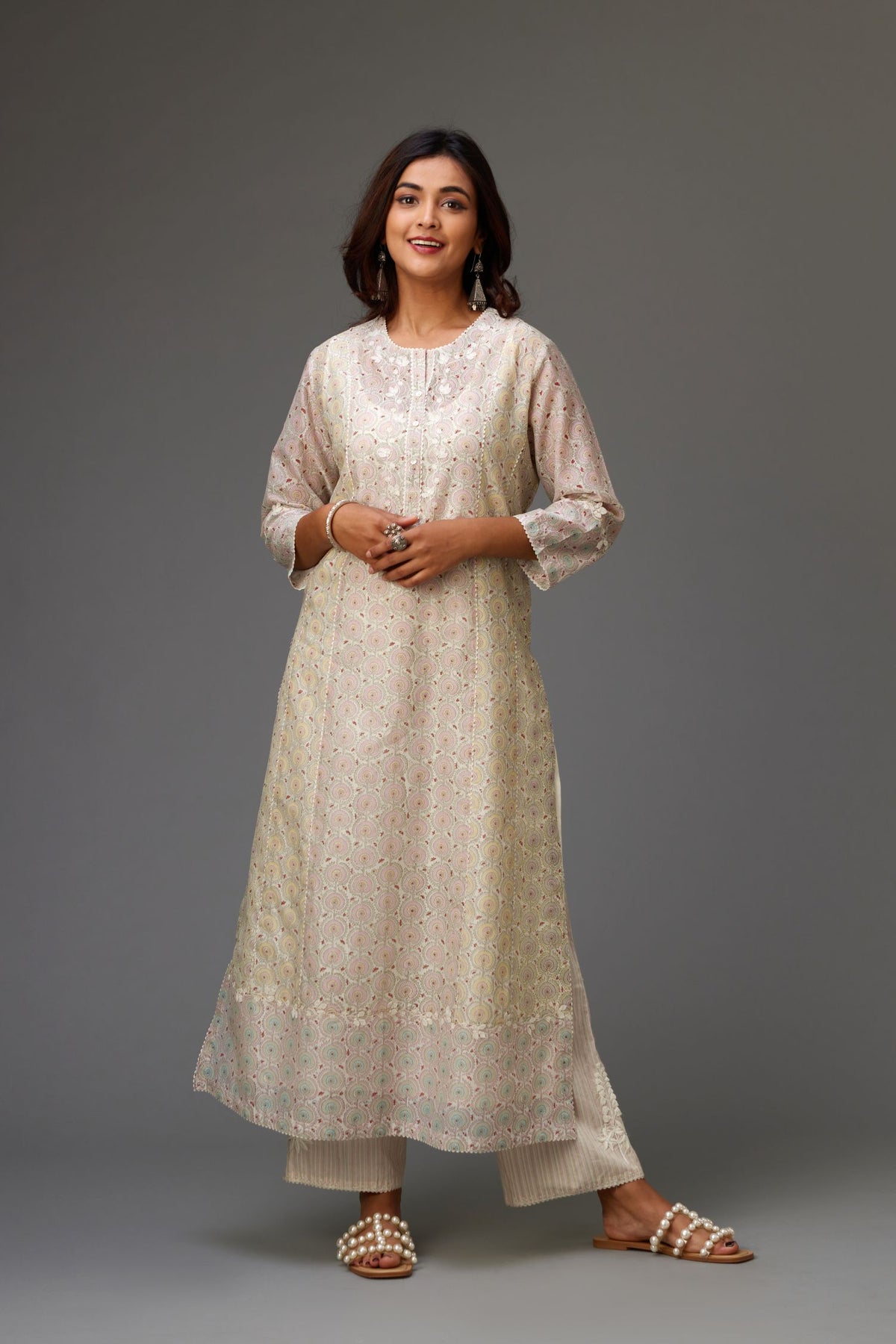 Silk Chanderi hand-block printed kurta set with multi-print panels, highlighted with white thread embroidery and chiffon flowers.