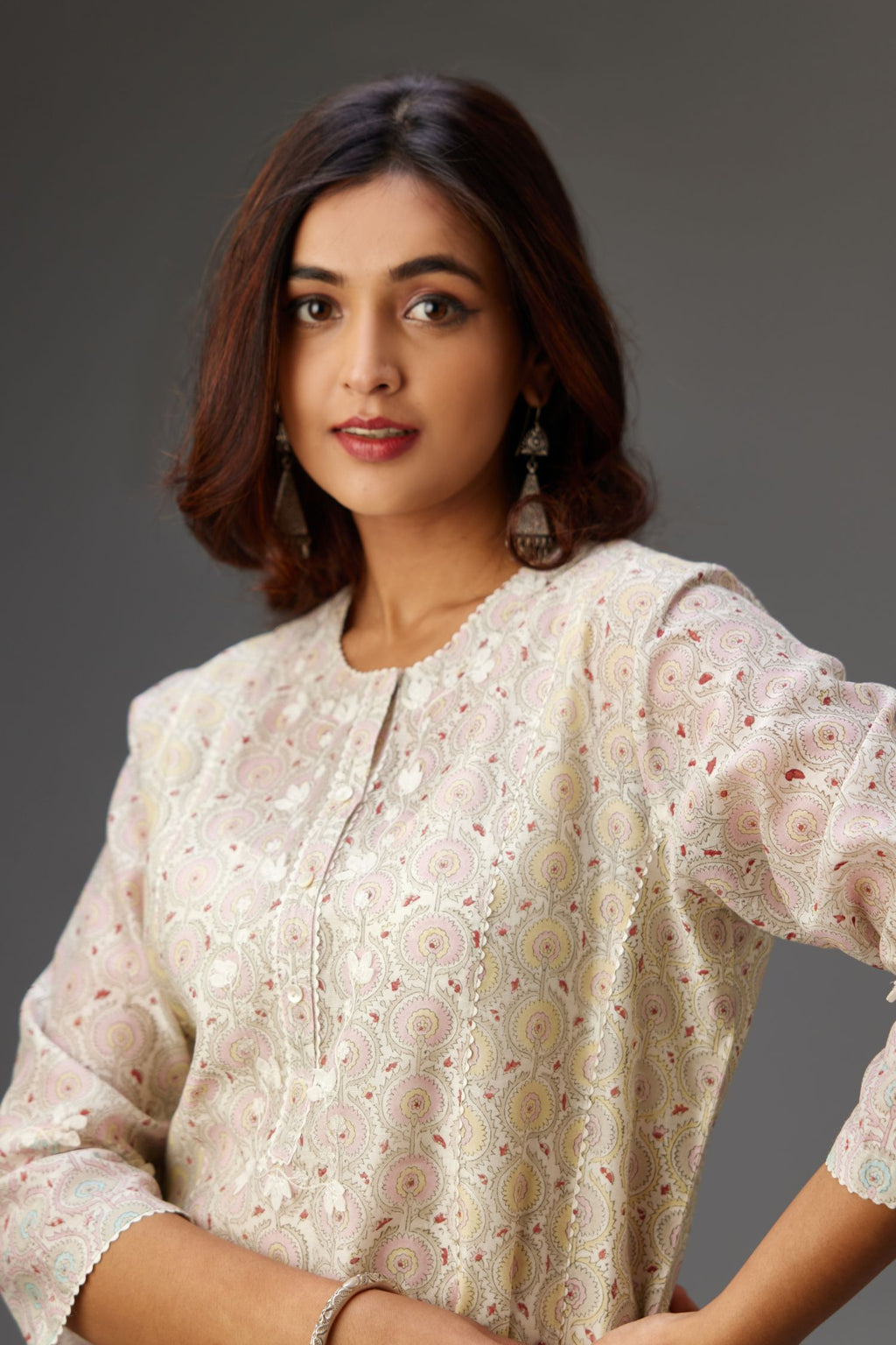 Silk Chanderi hand-block printed kurta set with multi-print panels, highlighted with white thread embroidery and chiffon flowers.