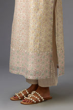 Silk Chanderi hand-block printed kurta set with multi-print panels, highlighted with white thread embroidery and chiffon flowers.