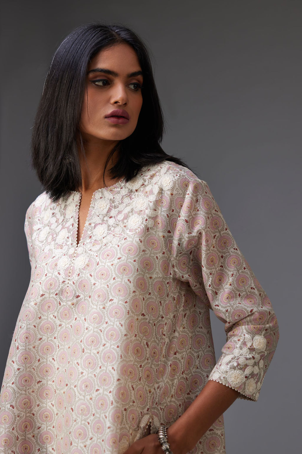 Pink & grey hand block printed short A-line kurta set with appliqué embroidery, highlighted with ric rac lace and sequins.