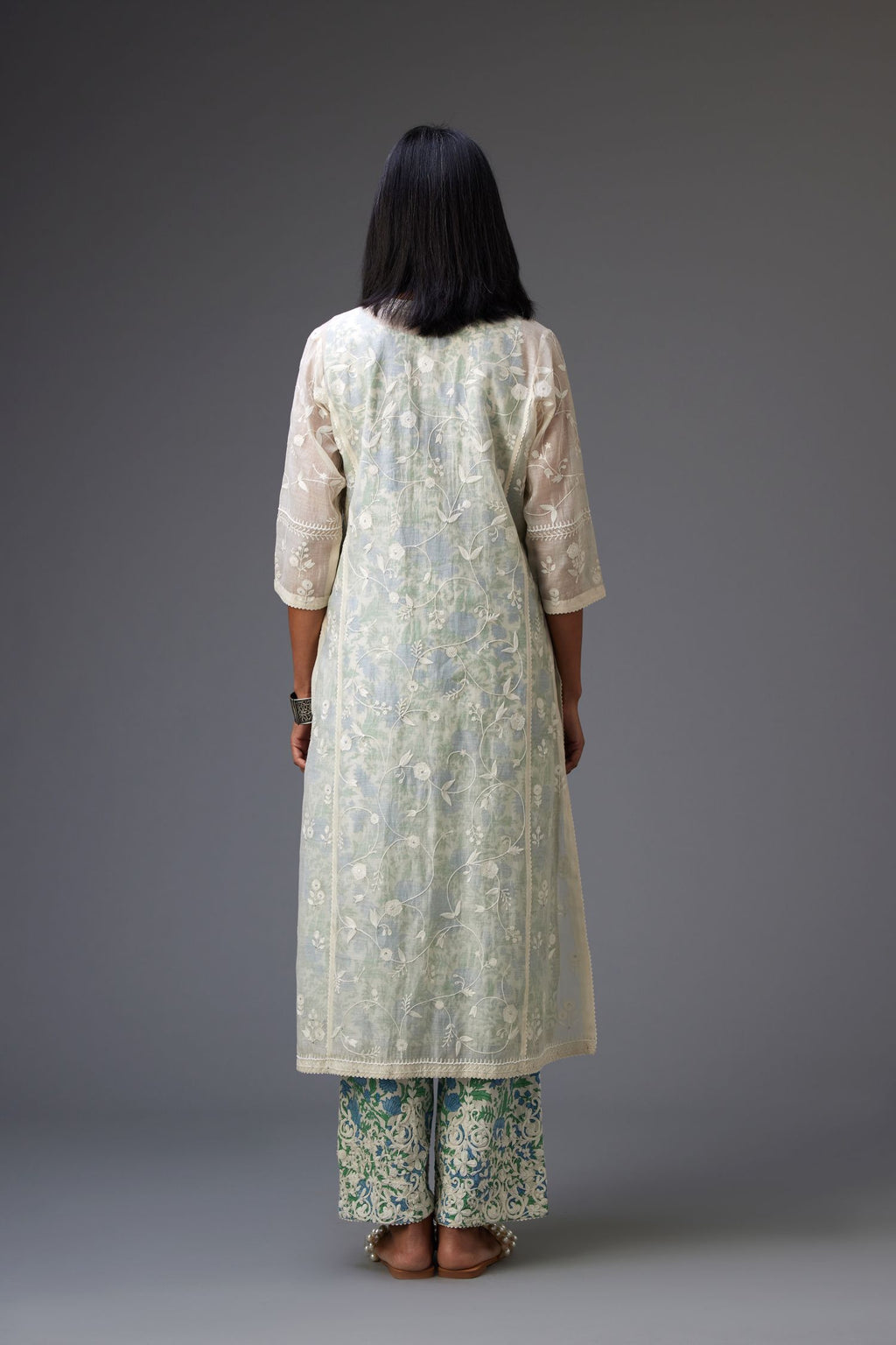 Off-white cotton chanderi kurta set with all-over jaal embroidery and small assorted flowers embroidery at side panells, highlighted with sequins handwork.
