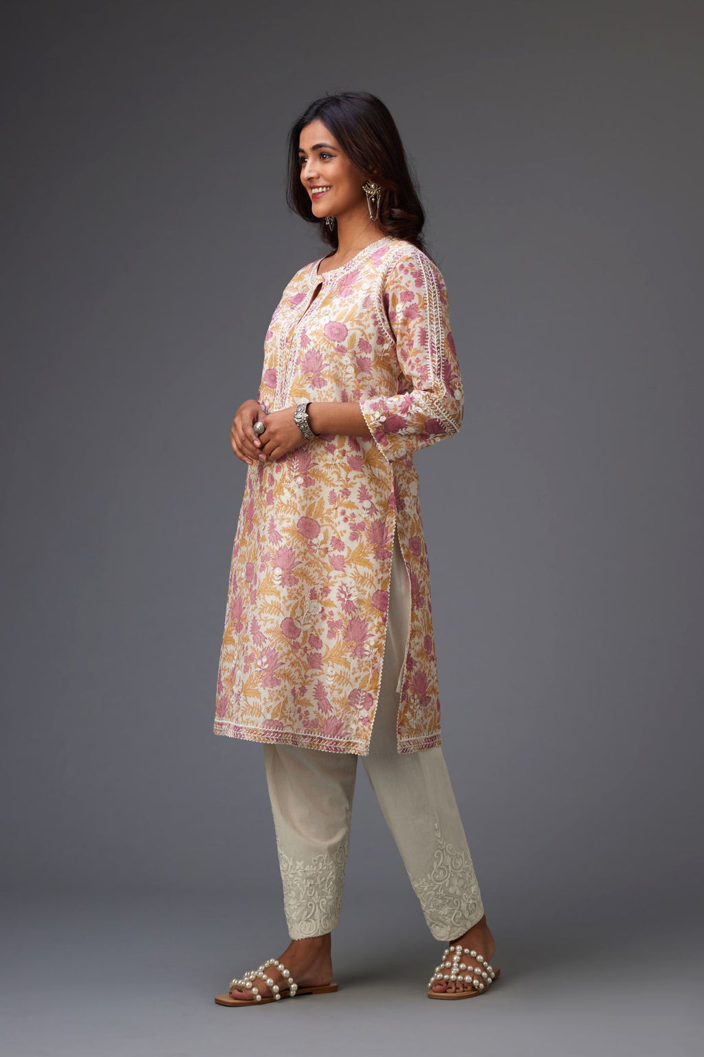 Pink and mustard hand block printed cotton chanderi short kurta set with all-over assorted embroidered flowers, highlighted with sequins handwork.