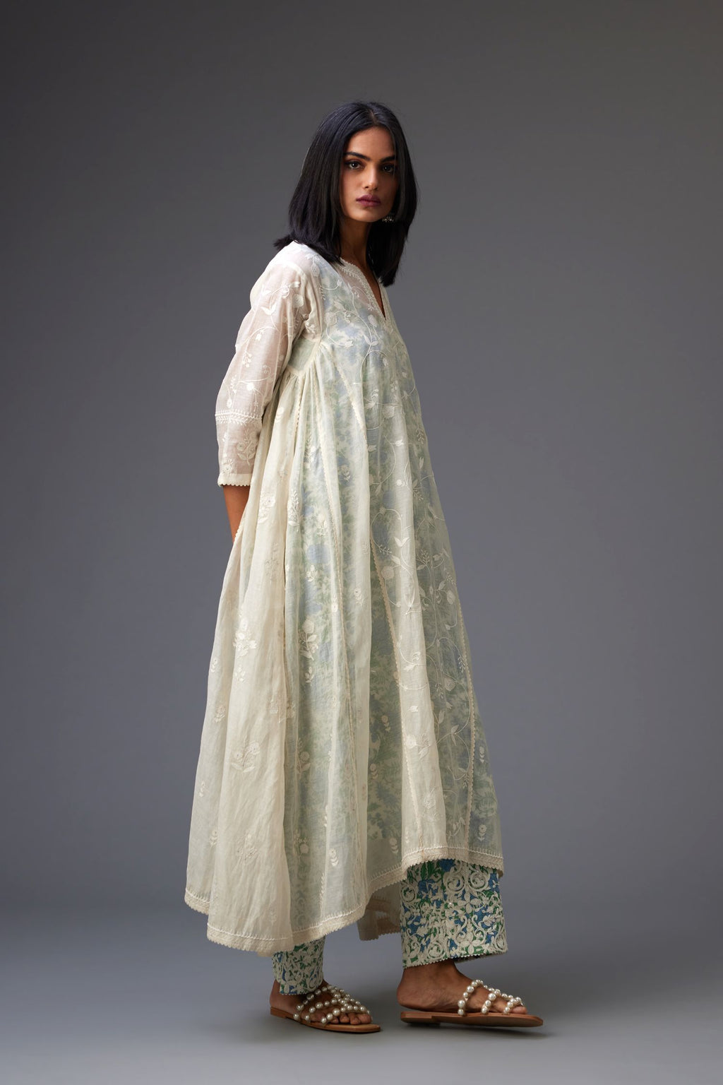 Off white cotton chanderi kurta set with asymmetric hem, highlighted with tonal colored thread embroidery and ric-rac lace at edges.