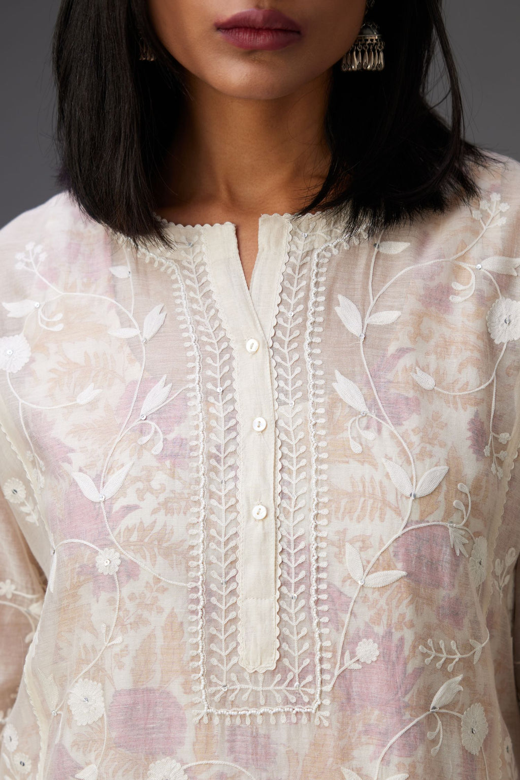 Off-white cotton chanderi kurta set with all-over jaal embroidery and small assorted flowers embroidery at side panells, highlighted with sequins handwork.
