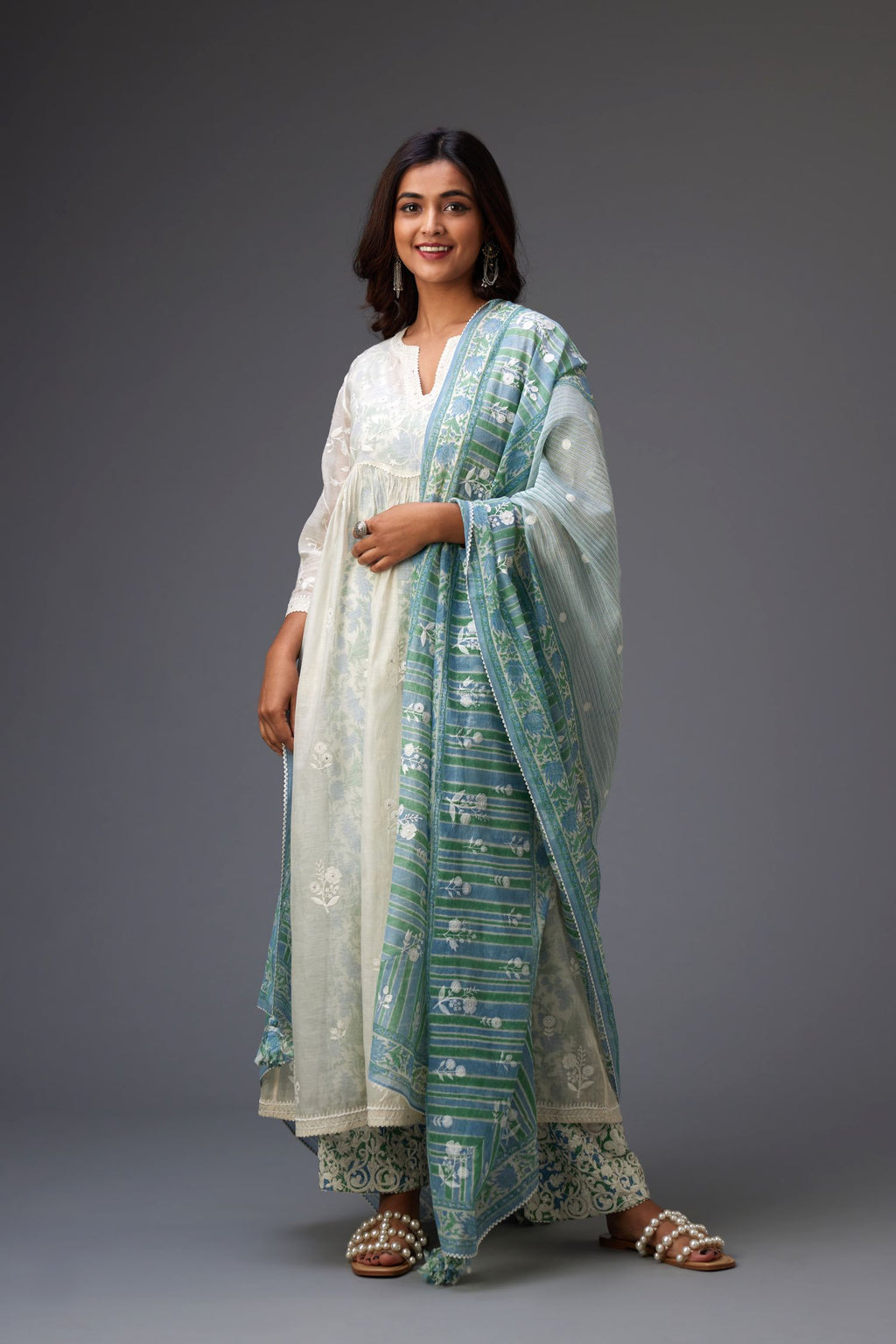 Cotton chanderi kurta set with wavy empire waistline and gathers, highlighted with all-over tonal colored thread embroidery and ric-rac detail.