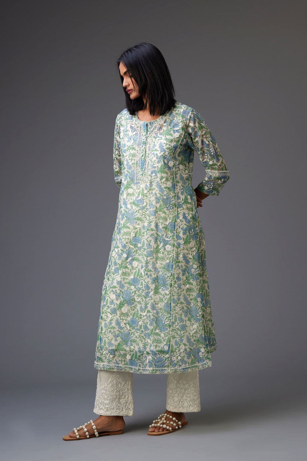 Blue and green hand block printed cotton chanderi kurta set with all-over jaal embroidery and small assorted flowers embroidery at side panells, highlighted with sequins handwork.