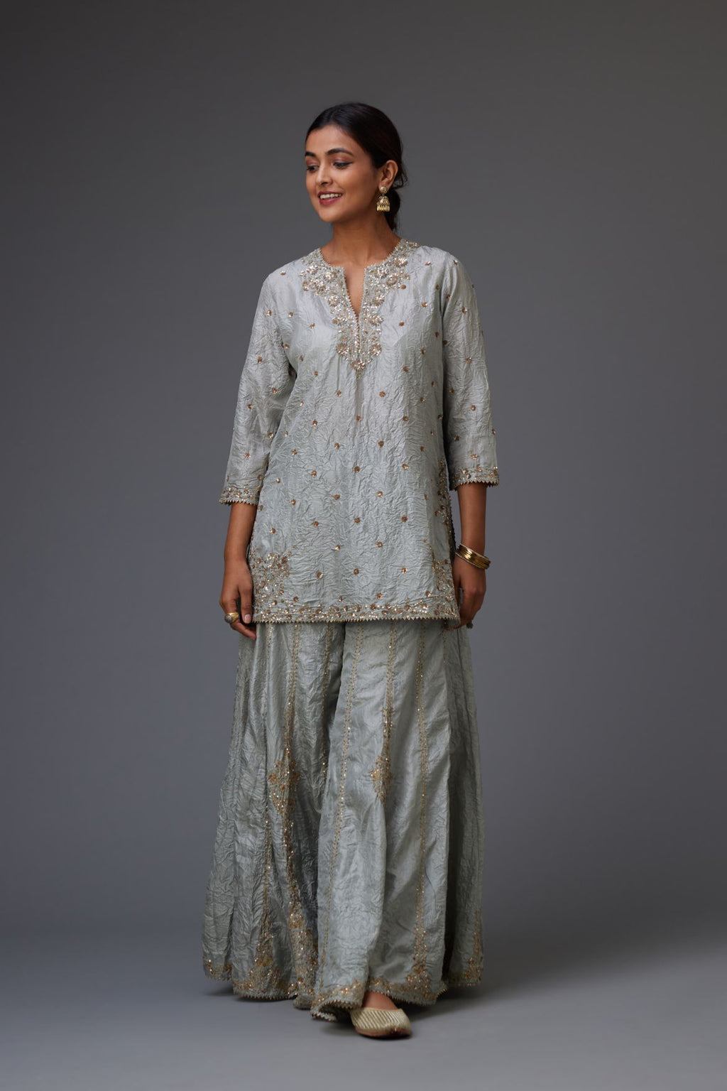 Blue hand crushed silk short kurta set with all-over gold sequins and zari handwork, highlighted with gota lace at edges.