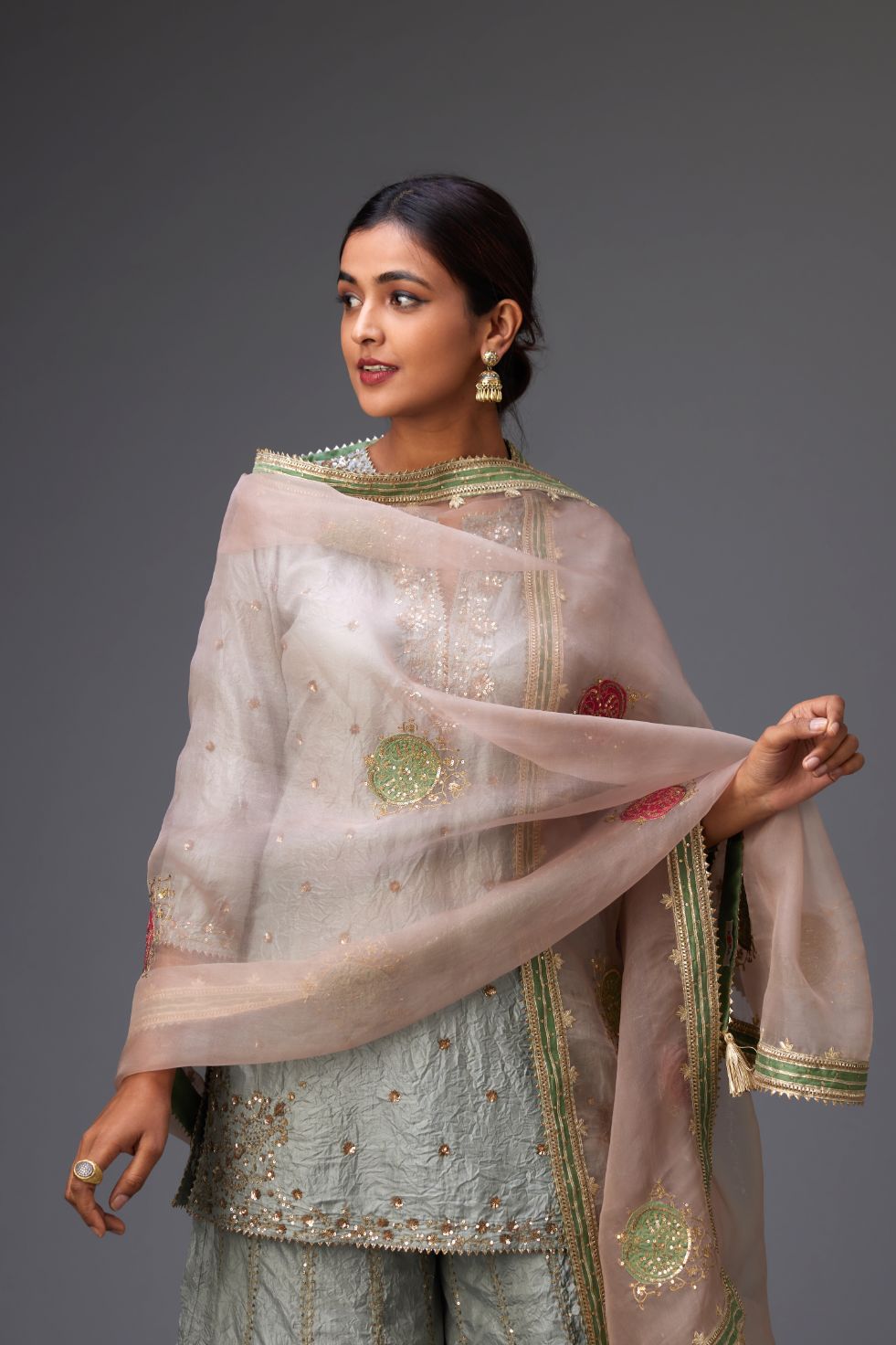 Old rose silk organza dupatta highlighted with all-over embroidered boota and contrast colored border running along all edges.