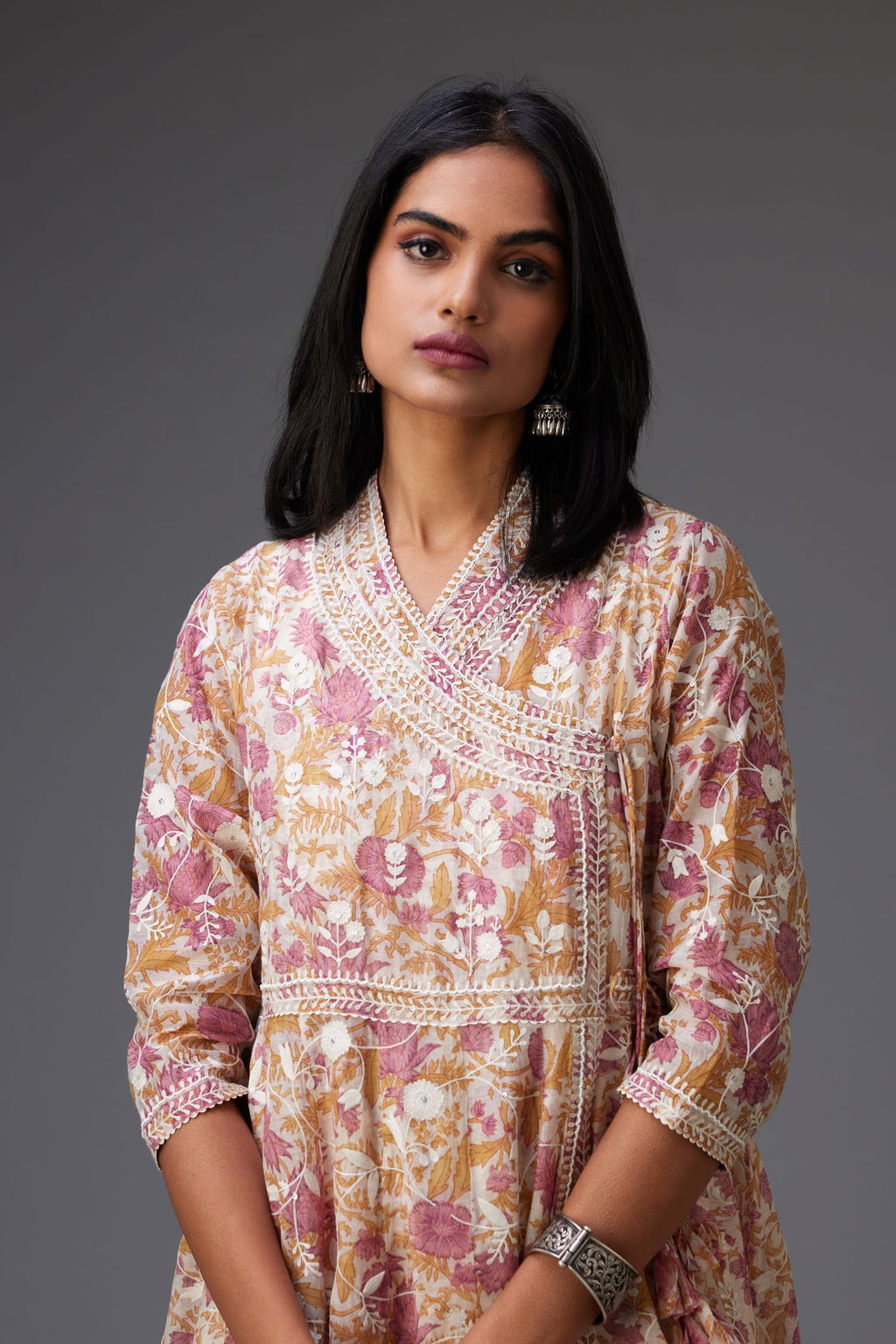 Pink and mustard hand block printed angrakha kurta set with white thread embroidery and sequins work all over.