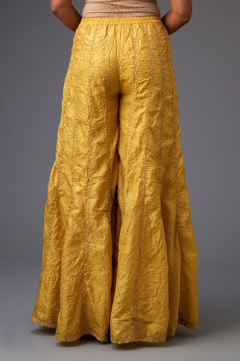 Yellow silk farshi with all-over sequins and zari work.