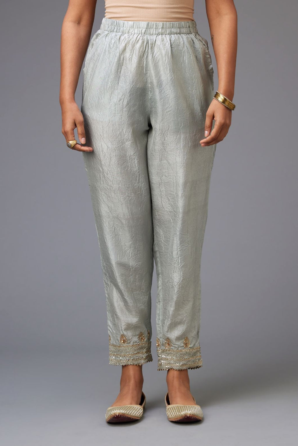 Blue hand crushed silk pants with embroidered sequins border at hem.