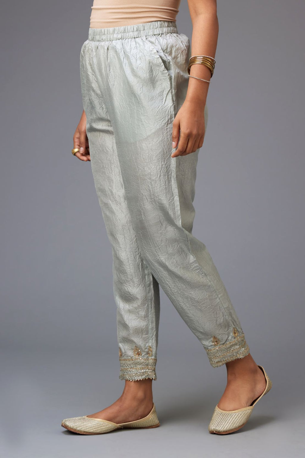 Blue hand crushed silk pants with embroidered sequins border at hem.